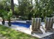 Seating and landscape around fiberglass pool