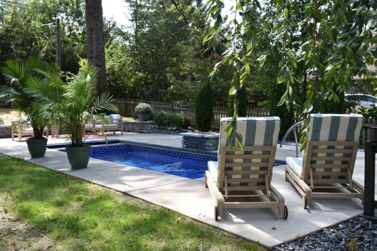 Take a Seat Around the Pool Seating and landscape around fiberglass pool