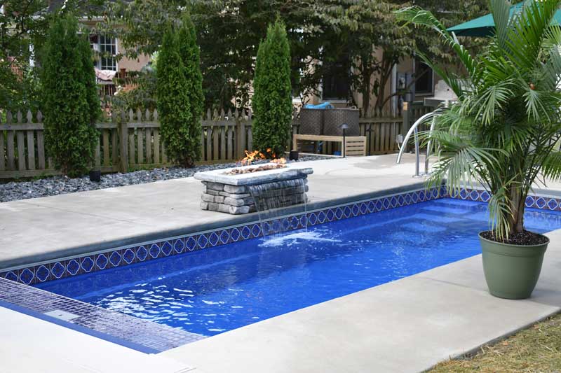 Inground Pool Tiling, Cement Patio and Firepit on the Side of Pool