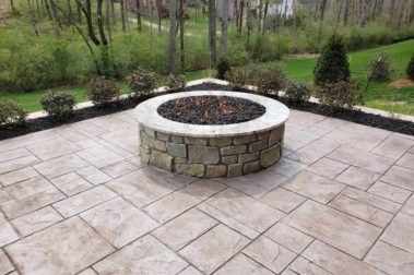 Stone Fire Pit and Patio behind home in Wooded Area