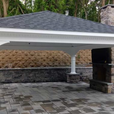 White Pavilion on Stone Patio with Fireplace