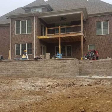 Construction of Retaining Wall behind Large Brick House