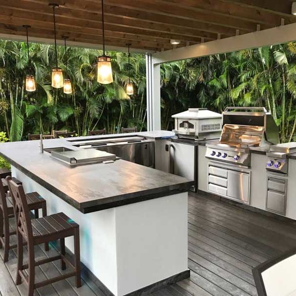 Outdoor Kitchen with Grill Surrounded by Greenery