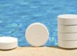 Chlorine Tablets for Pool Sanitizing with Pool in the Background