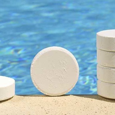 Chlorine Tablets for Pool Sanitizing with Pool in the Background