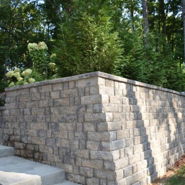 Brick Retaining wall and cement staircase with trees in the background