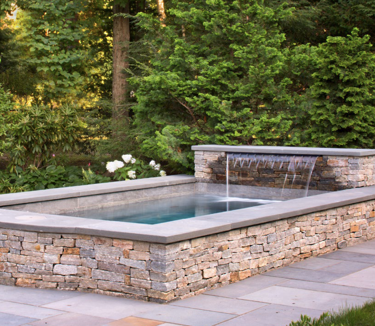 Cocktail pool with waterfall and stone patio