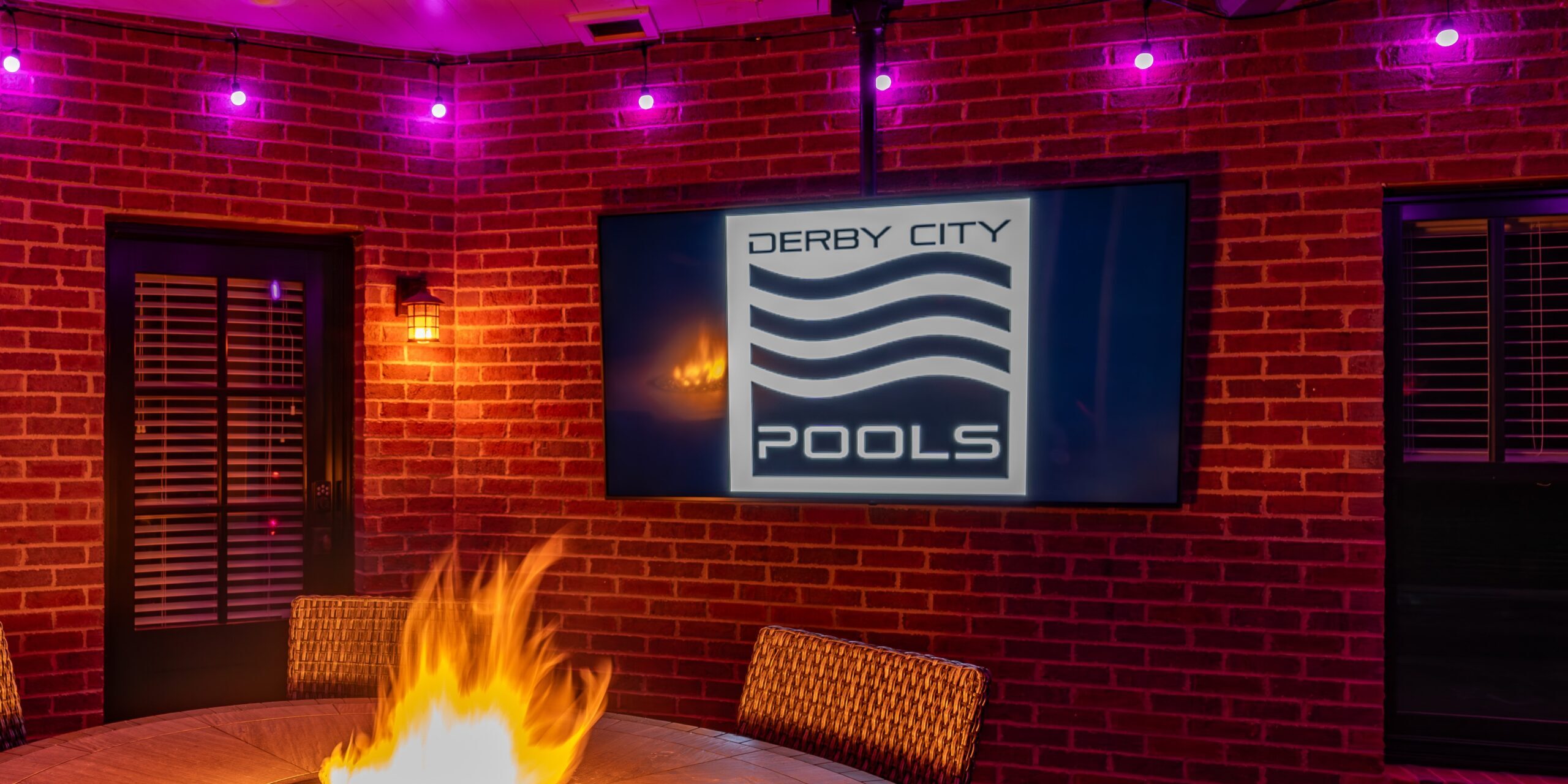 Outdoor TV in front of fire pit, installed by Derby City Pools