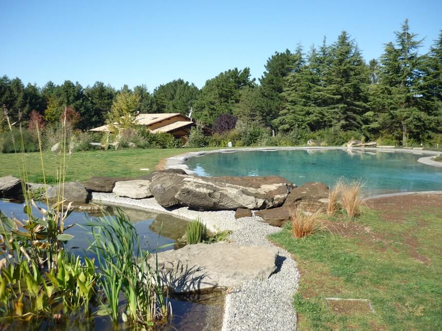 Very large biodesign pool next to a natural pond
