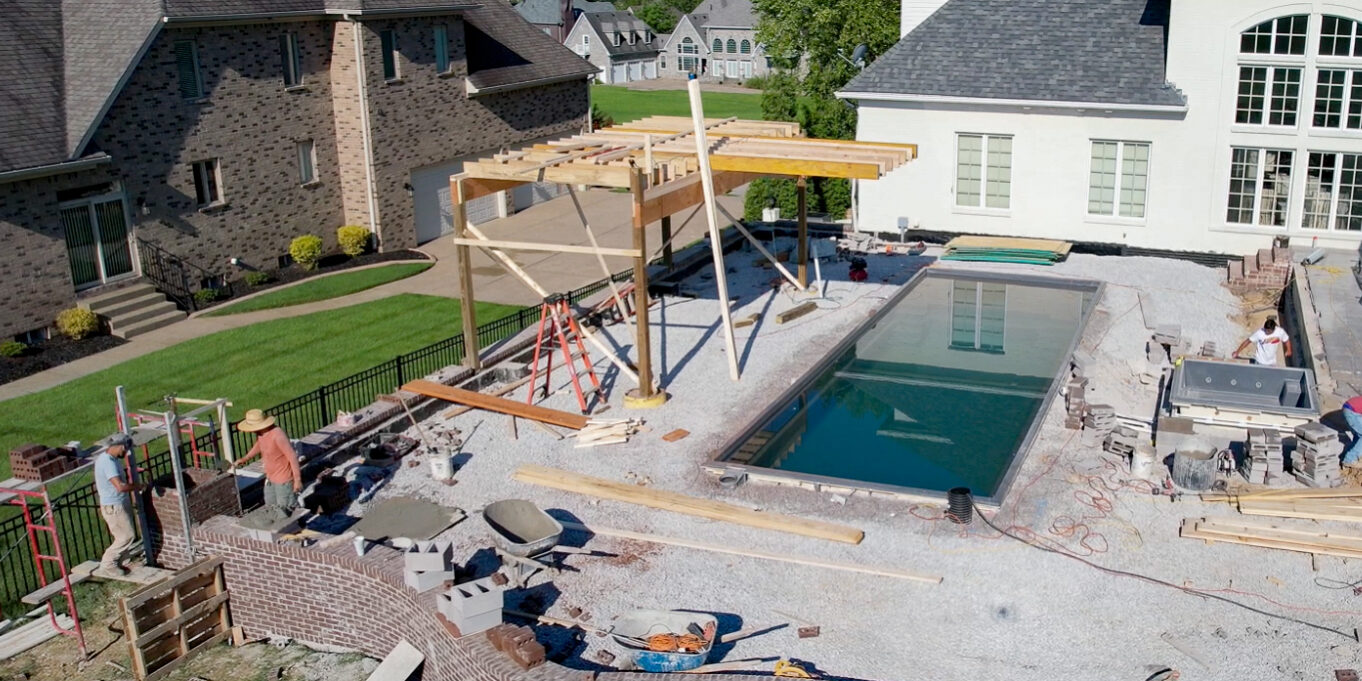 Pool contractors installing a new swimming pool