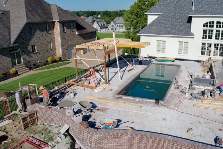 Swimming Pool Installation Pool contractors installing a new swimming pool
