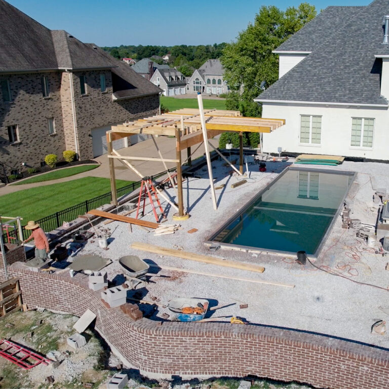 Pool contractors installing a new swimming pool